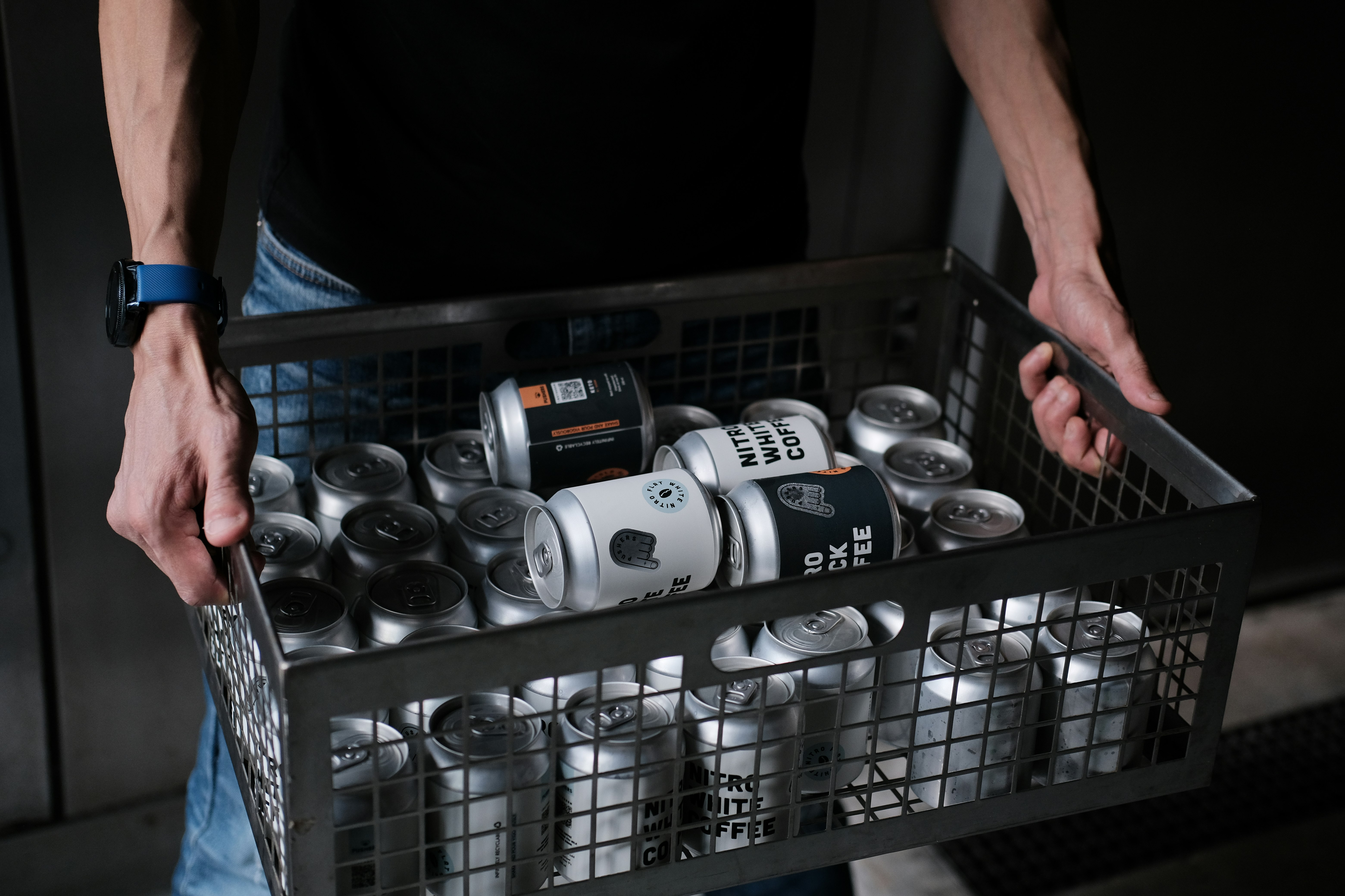 white and black ceramic mugs on stainless steel rack